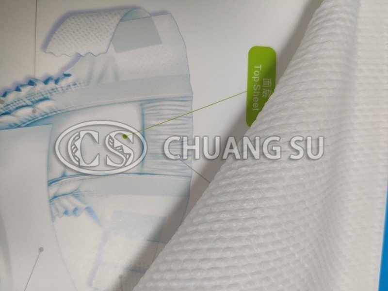 Perforated and embossed non-woven fabric - perforated surface layer